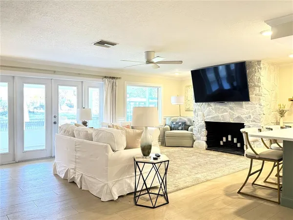a living room with furniture a fireplace and a flat screen tv