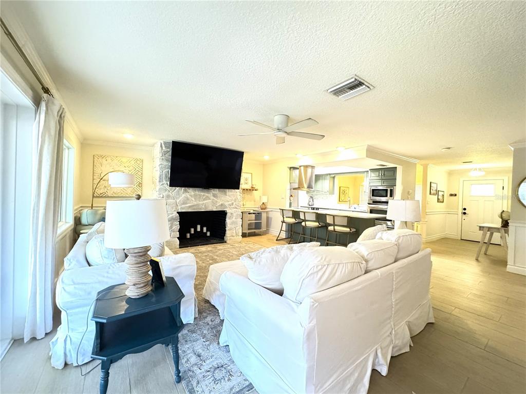 1004 Southeast 5th Avenue Crystal River, FL 34429 - Photo 6 of 43 a living room with furniture a fireplace and a flat screen tv