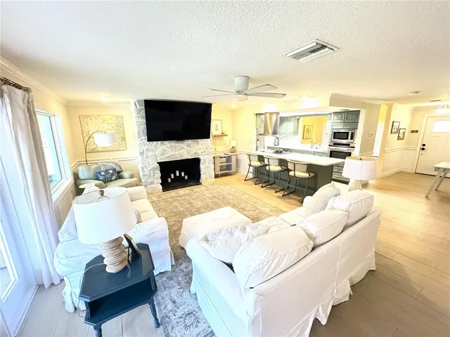 a living room with furniture fireplace and a flat screen tv