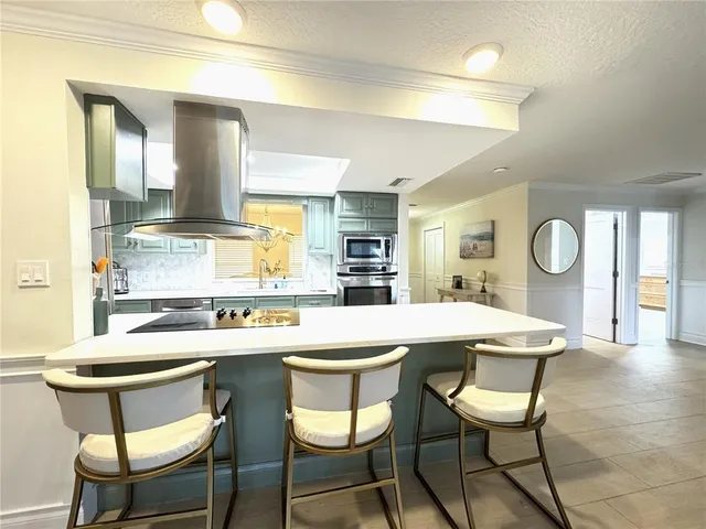 a kitchen with a dining table chairs and white cabinets