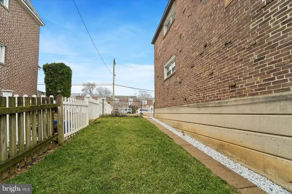a view of a backyard with wooden fence