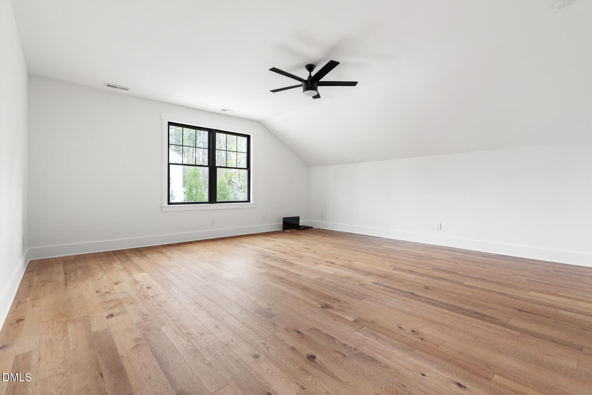 1117 Barley Stone Way Raleigh, NC 27603 - Photo 38 of 59 an empty room with wooden floor fan and windows