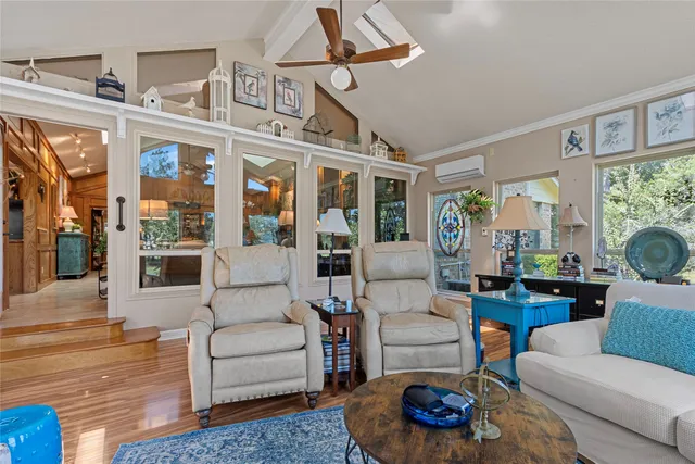 a living room with furniture fireplace and a large window