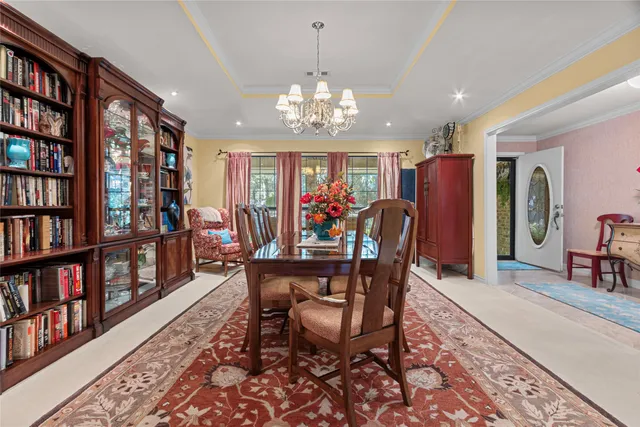 a view of a dining room with furniture and book shelf
