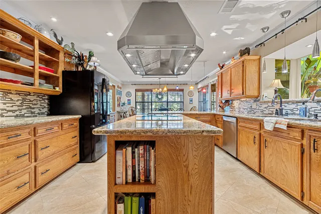 a kitchen with stainless steel appliances granite countertop a stove and cabinets