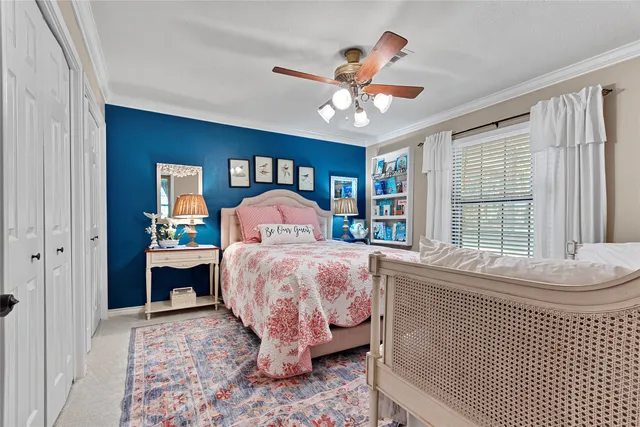 a bedroom with a large bed and a chandelier