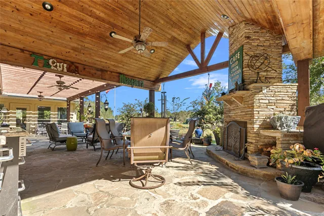 a view of a patio with a table and chairs under an umbrella
