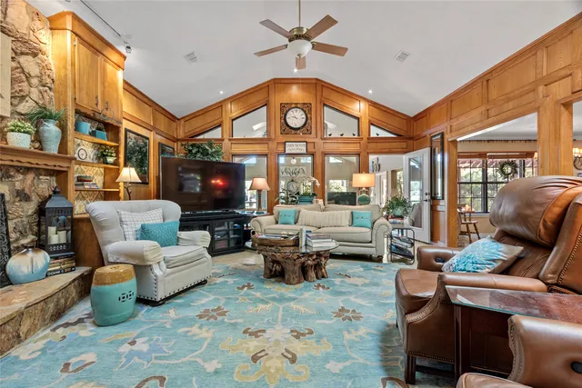 a living room with furniture a fireplace and a flat screen tv
