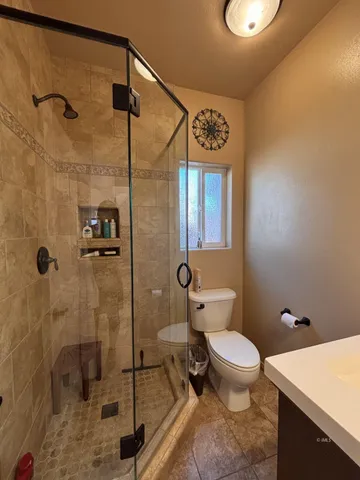 a bathroom with a toilet and a shower