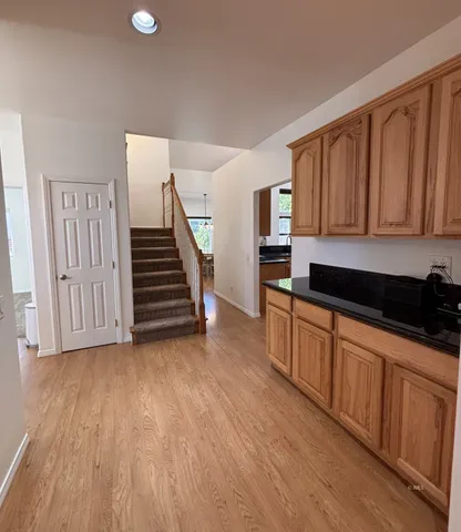 a kitchen with wooden floors and a sink