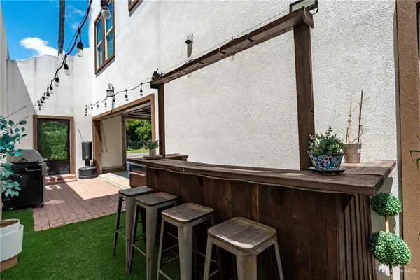 a view of balcony with chairs and kitchen view