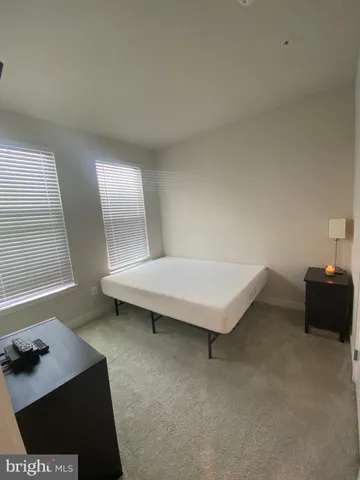 a view of a hallway with wooden floor and entryway