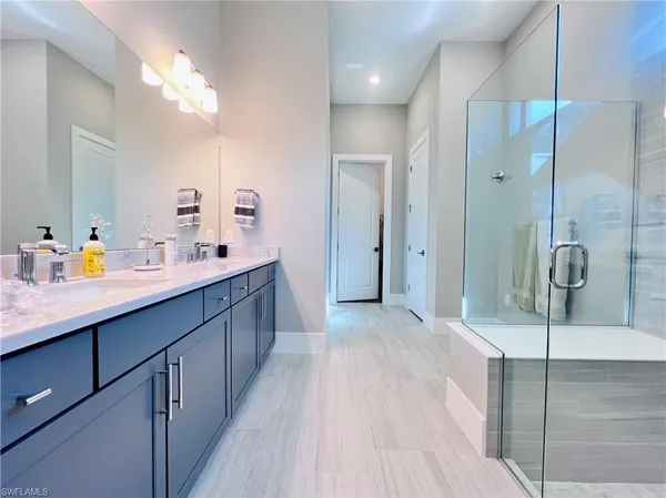 a bathroom with a double vanity sink mirror and double