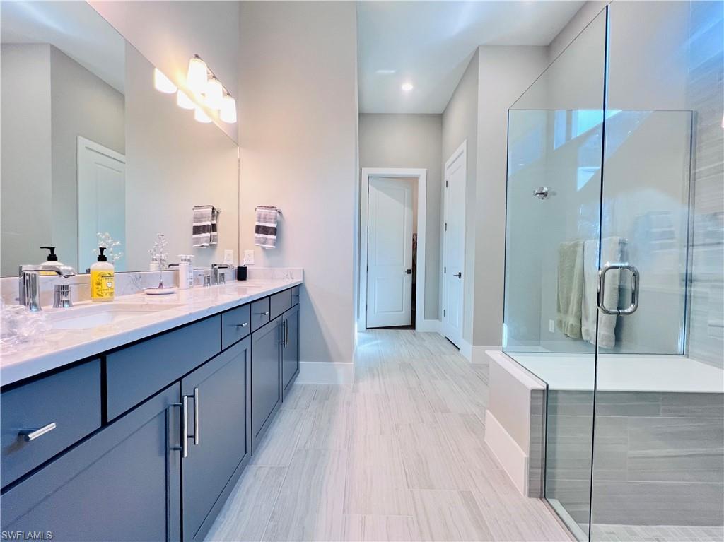9124 Raintree Street Naples, FL 34114 - Photo 18 of 42 a bathroom with a double vanity sink mirror and double