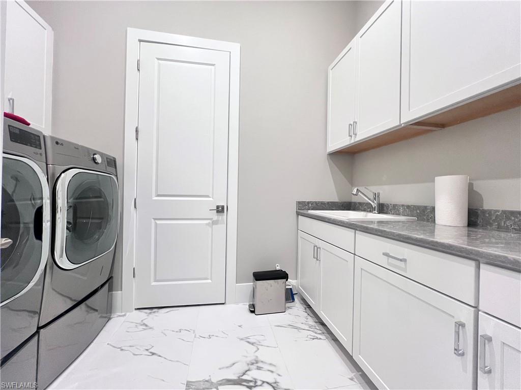 9124 Raintree Street Naples, FL 34114 - Photo 19 of 42 a utility room with sink dryer and washer