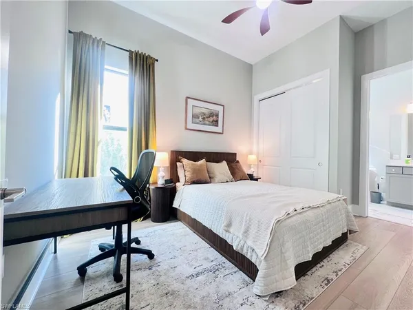 a bedroom with a bed and a desk