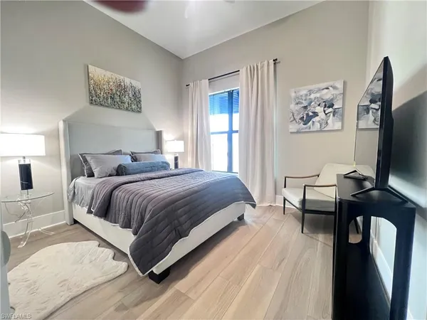 a bedroom with a bed and a flat screen tv