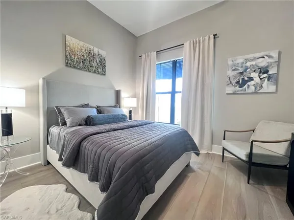 a bedroom with bed and a window