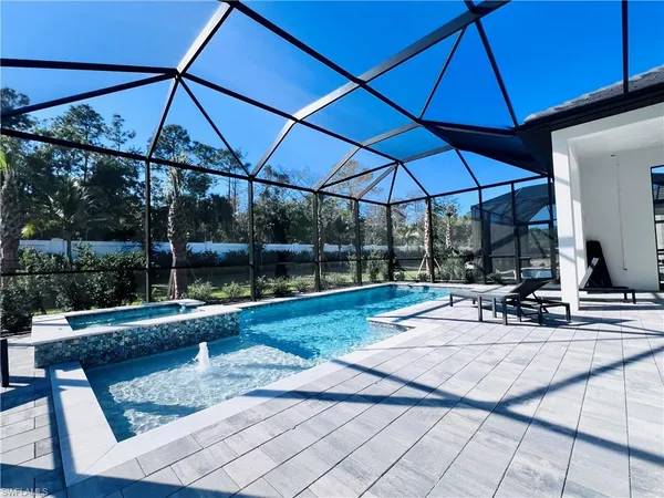 a view of a patio with a table and chairs under an umbrella