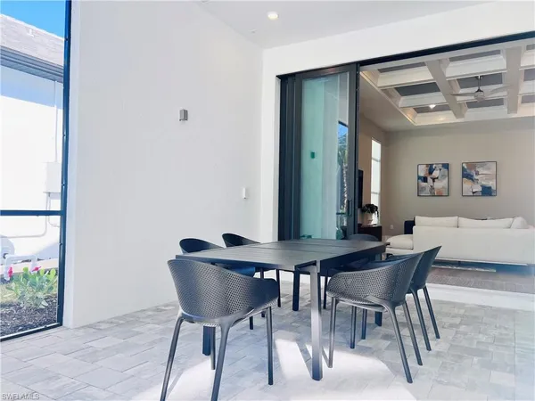 a view of a dining room with furniture and a potted plant