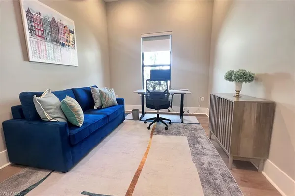 a living room with furniture and a rug