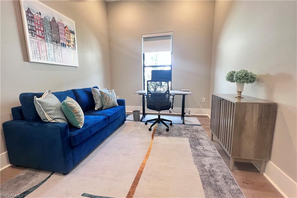 9124 Raintree Street Naples, FL 34114 - Photo 31 of 42 a living room with furniture and a rug