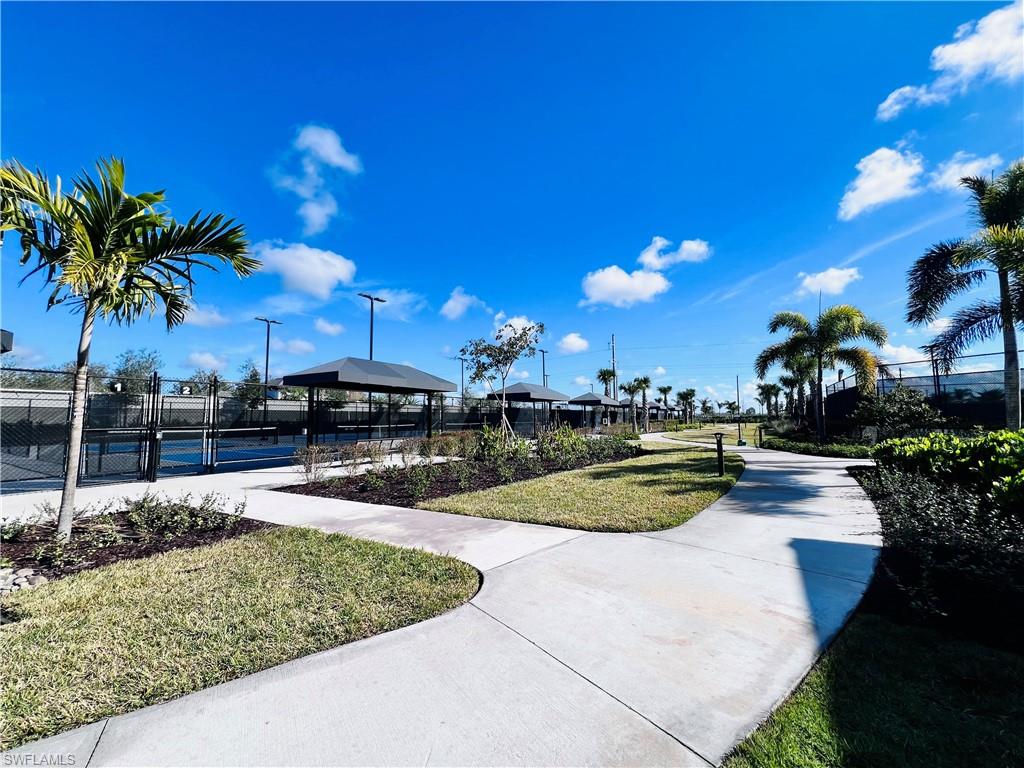 9124 Raintree Street Naples, FL 34114 - Photo 38 of 42 a view of a swimming pool with outdoor seating