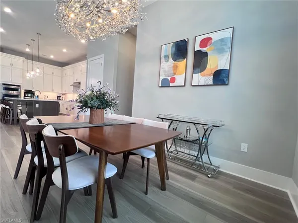 a view of a dining room with furniture and wooden floor