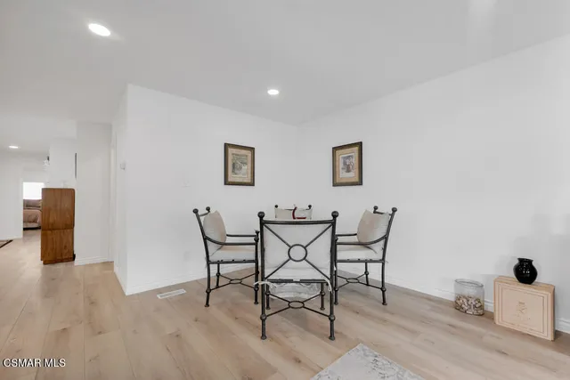 a view of a room with furniture and wooden floor
