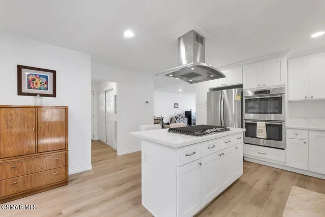 a kitchen that has a table and chairs in it