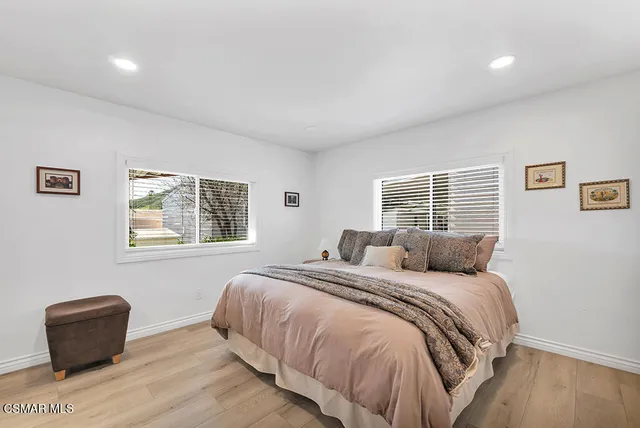 a bedroom with a bed and a couch