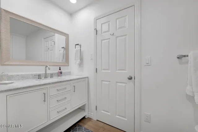 a view of an empty room with a fireplace and windows