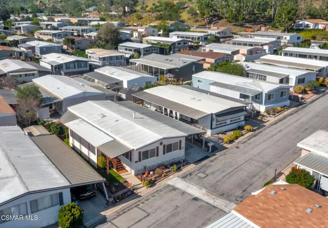 a sign board with a play ground and trees