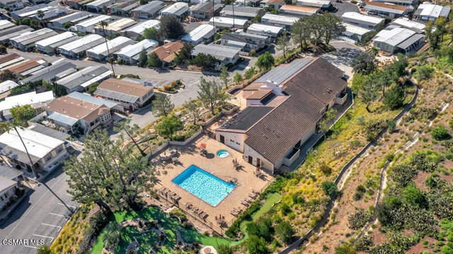 a room with pool table and windows