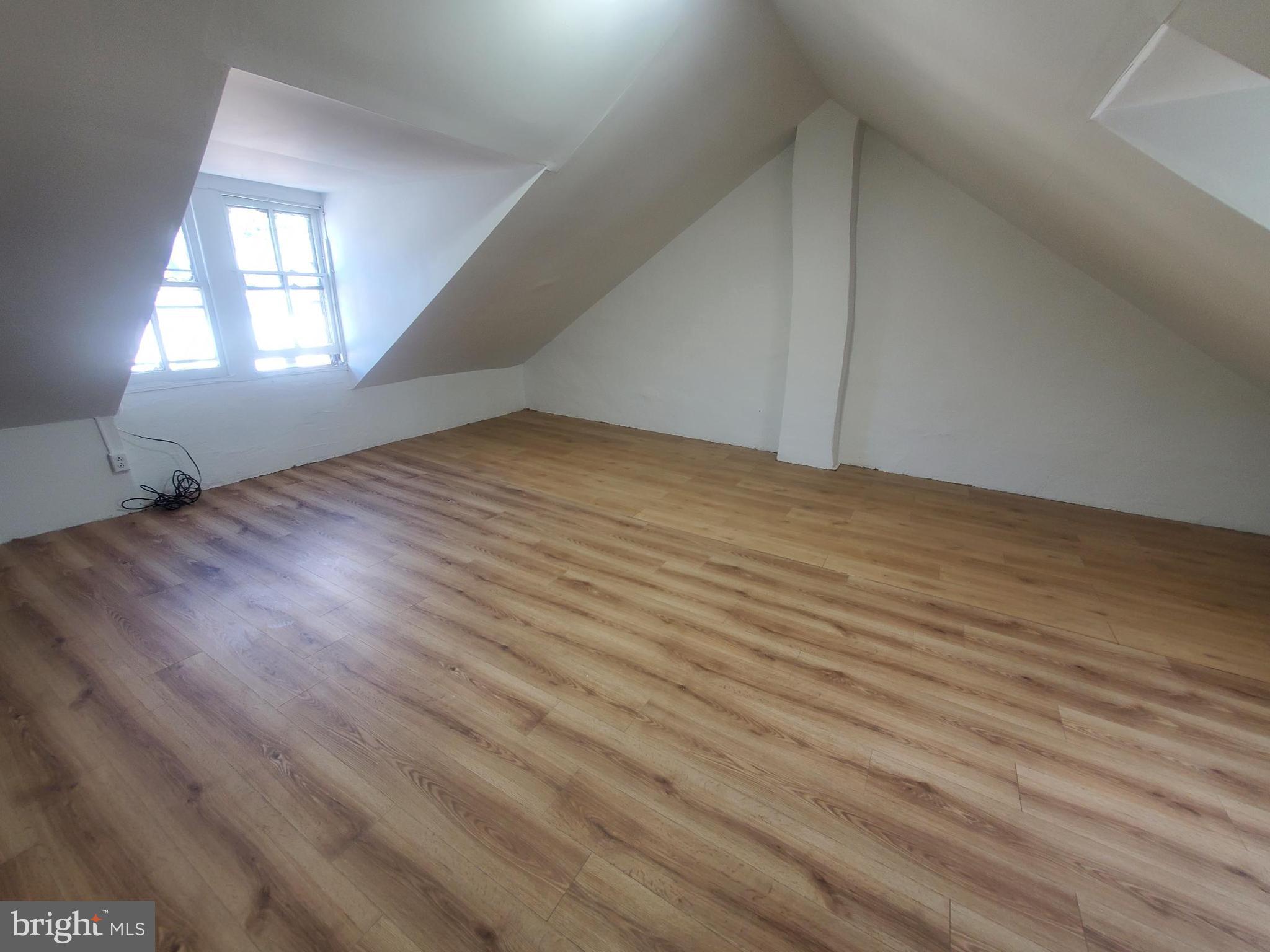 608 North 10th Street, Unit 2 Reading, PA 19604 - Photo 13 of 15 an empty room with wooden floor and windows