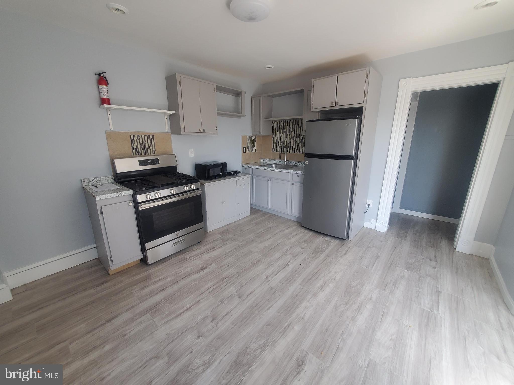 608 North 10th Street, Unit 2 Reading, PA 19604 - Photo 2 of 15 a kitchen with a refrigerator and a stove top oven