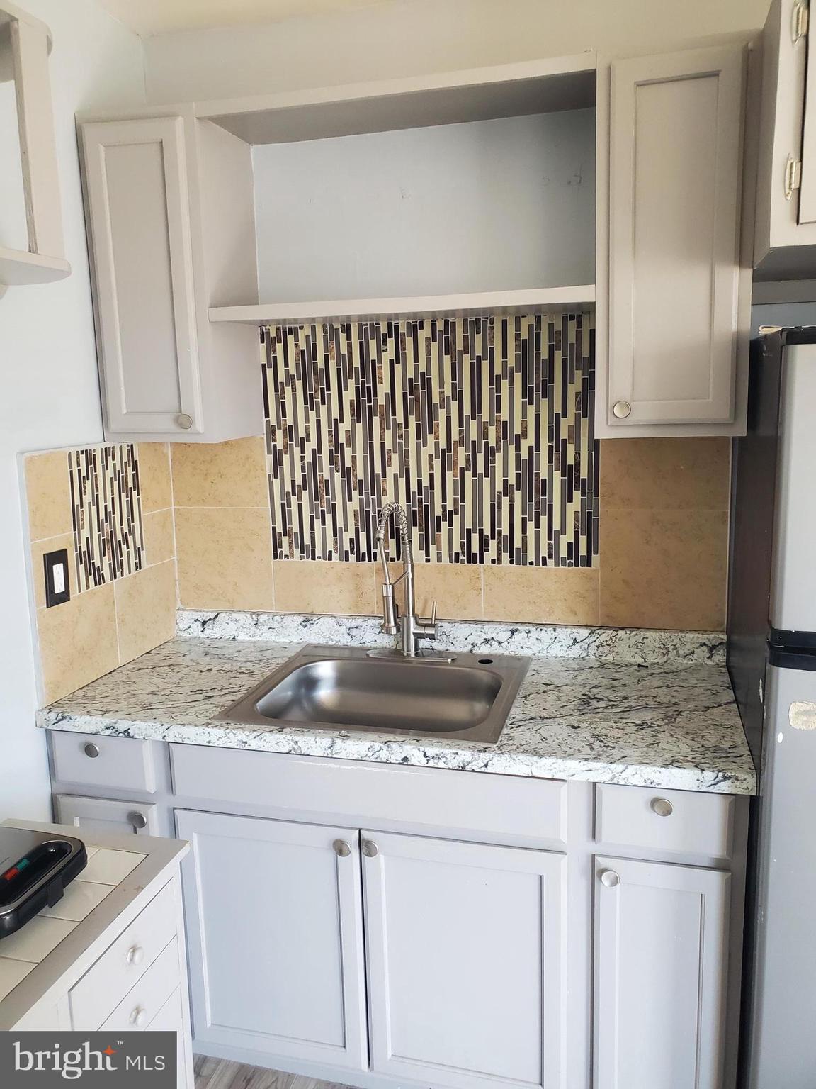 608 North 10th Street, Unit 2 Reading, PA 19604 - Photo 3 of 15 a kitchen with granite countertop a sink and a stove