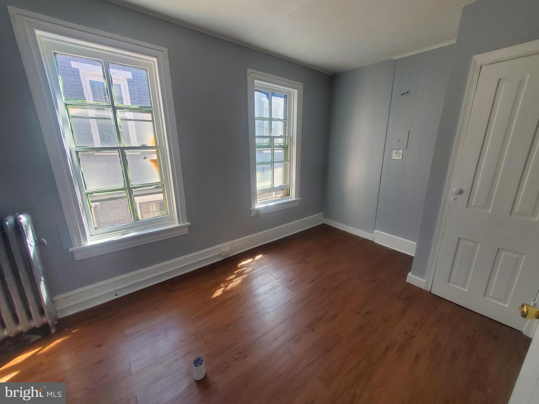 608 North 10th Street, Unit 2 Reading, PA 19604 - Photo 6 of 15 a view of an empty room with wooden floor and a window