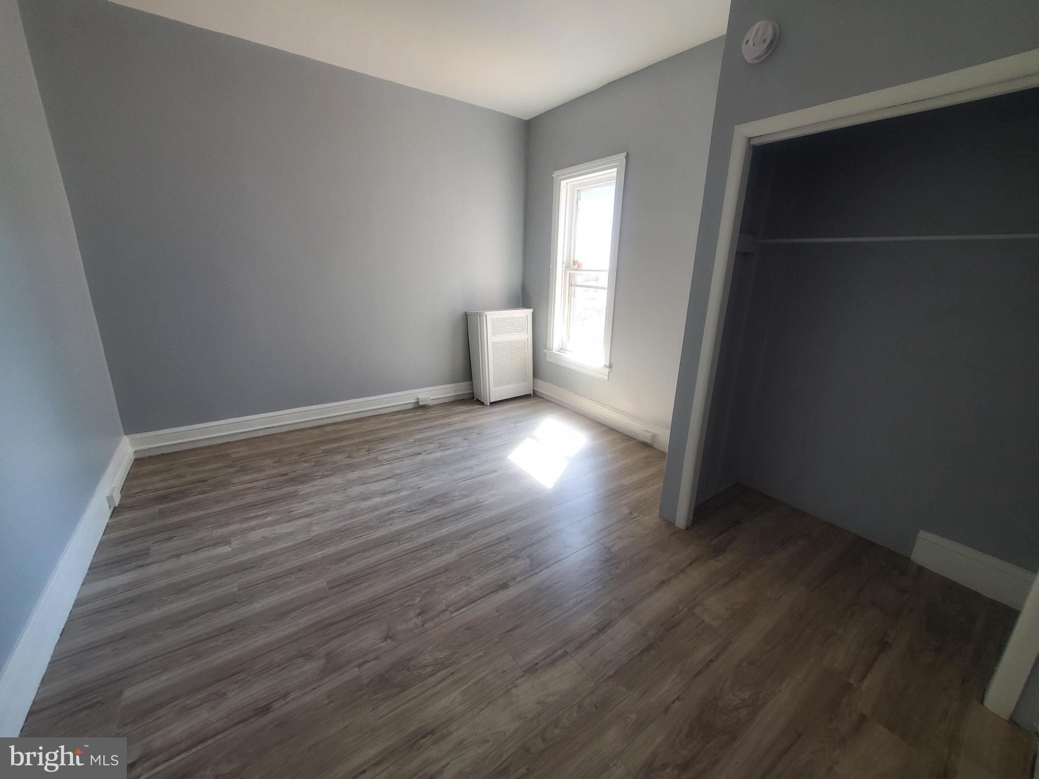 608 North 10th Street, Unit 2 Reading, PA 19604 - Photo 8 of 15 wooden floor in an empty room with a window