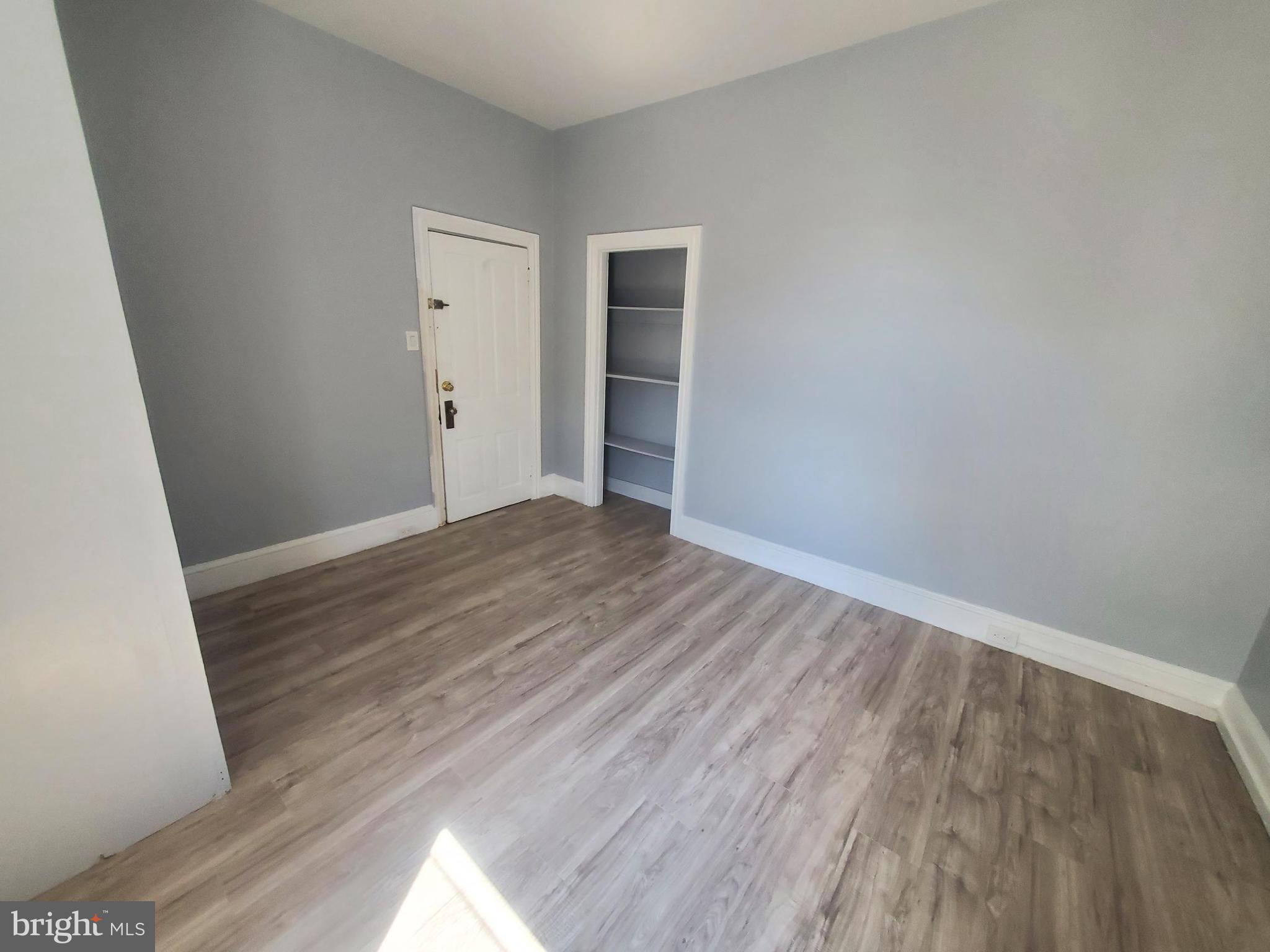 608 North 10th Street, Unit 2 Reading, PA 19604 - Photo 9 of 15 a view of an empty room with wooden floor and a window