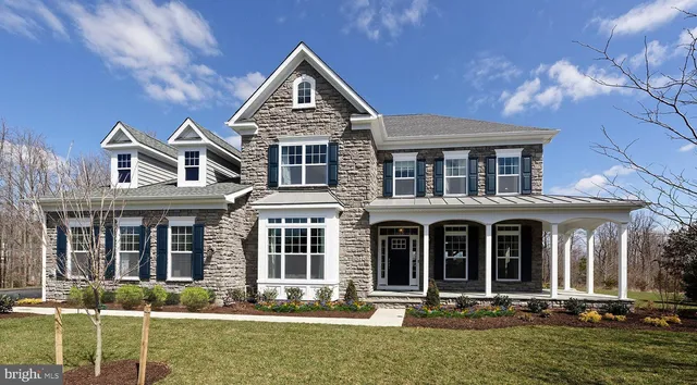 front view of a brick house with a yard