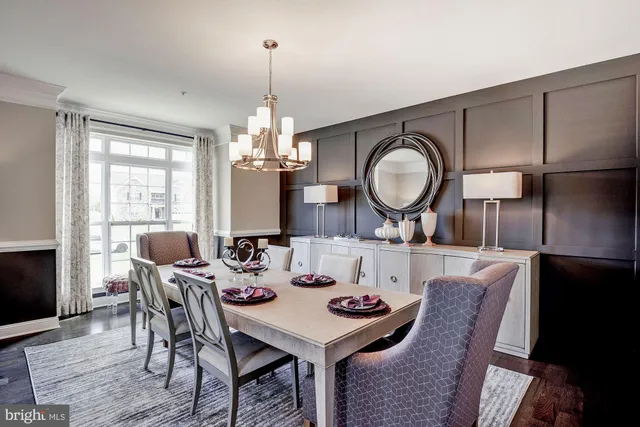 a view of a dining room with furniture and chandelier