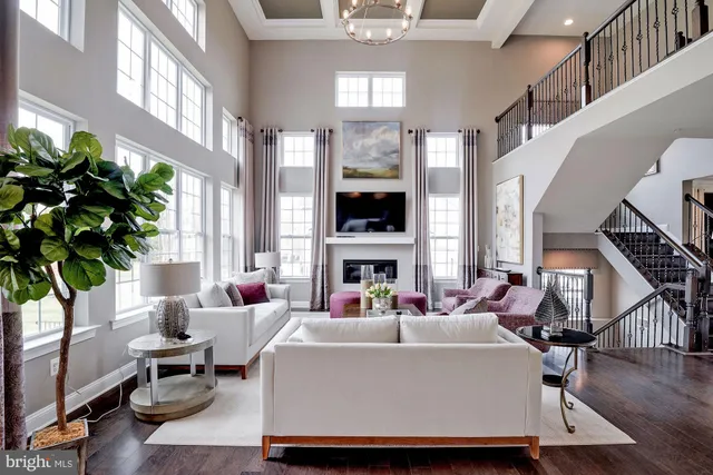 a living room with fireplace furniture and a large window