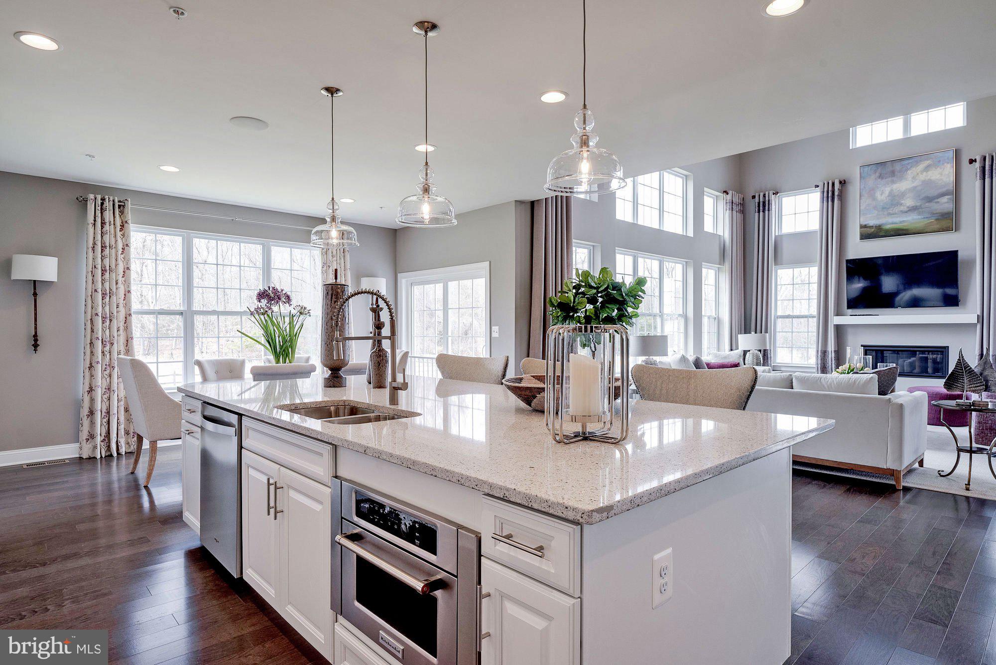 5705 Iron Stone Road Lothian, MD 20711 - Photo 4 of 17 a kitchen with stainless steel appliances granite countertop a sink a stove and wooden floor