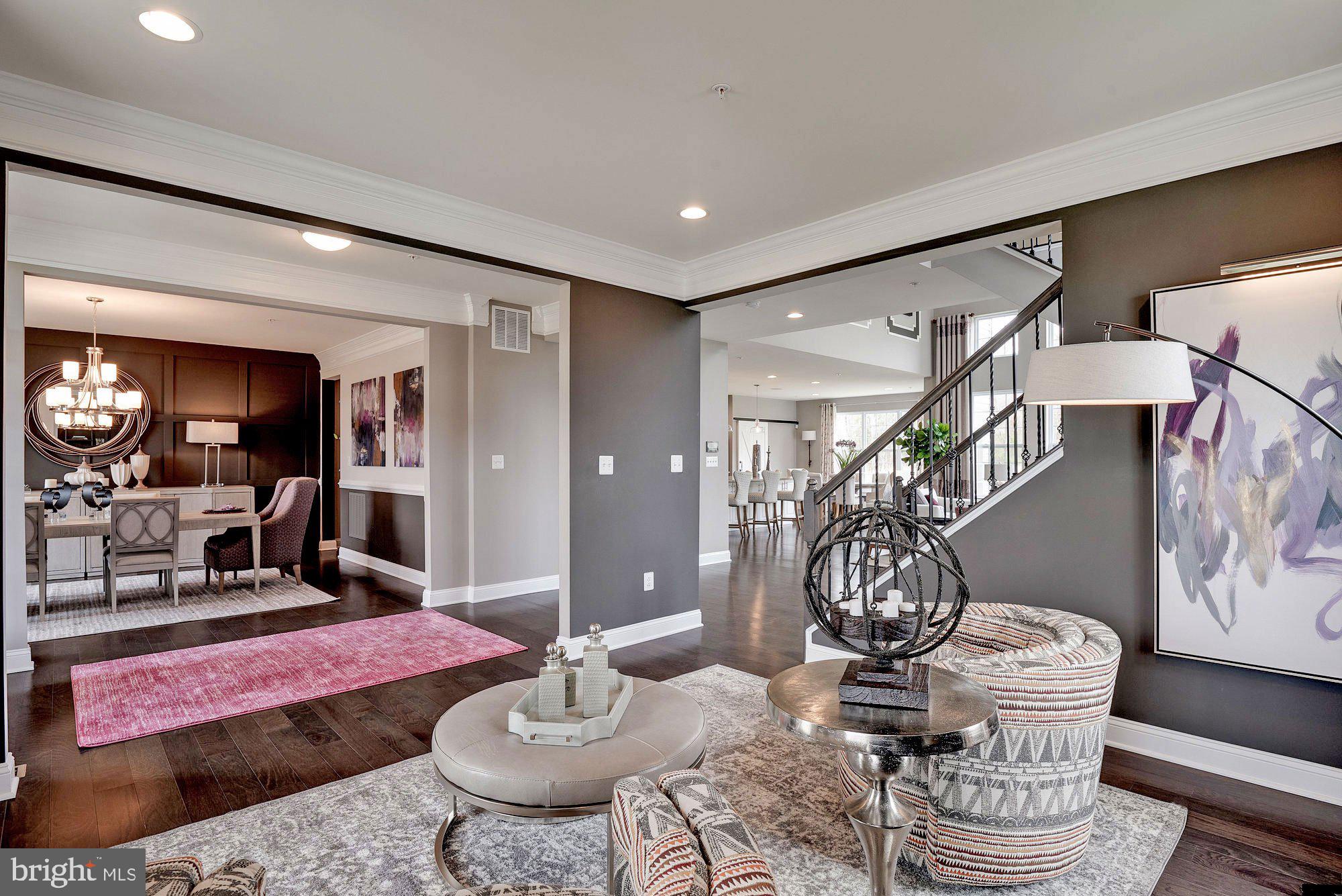 5705 Iron Stone Road Lothian, MD 20711 - Photo 5 of 17 a living room with furniture and a chandelier