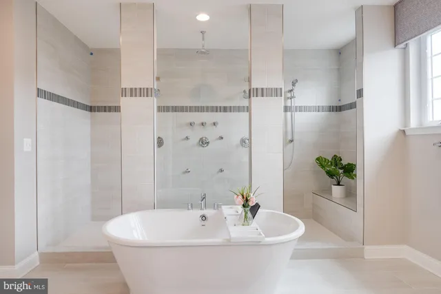 a bathroom with a white bath tub a shower and a toilet