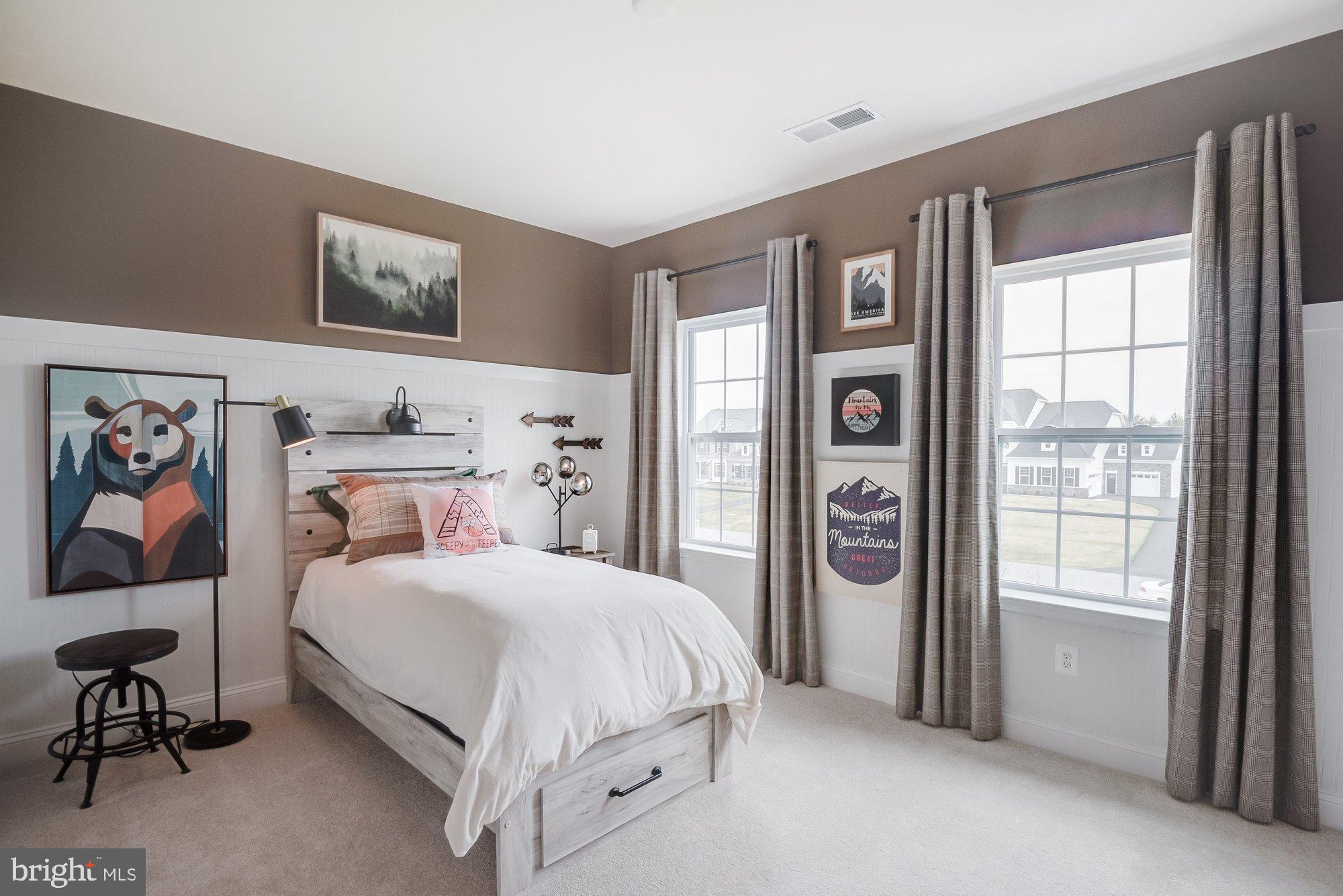 5705 Iron Stone Road Lothian, MD 20711 - Photo 10 of 17 a bedroom with a bed and a painting on the wall