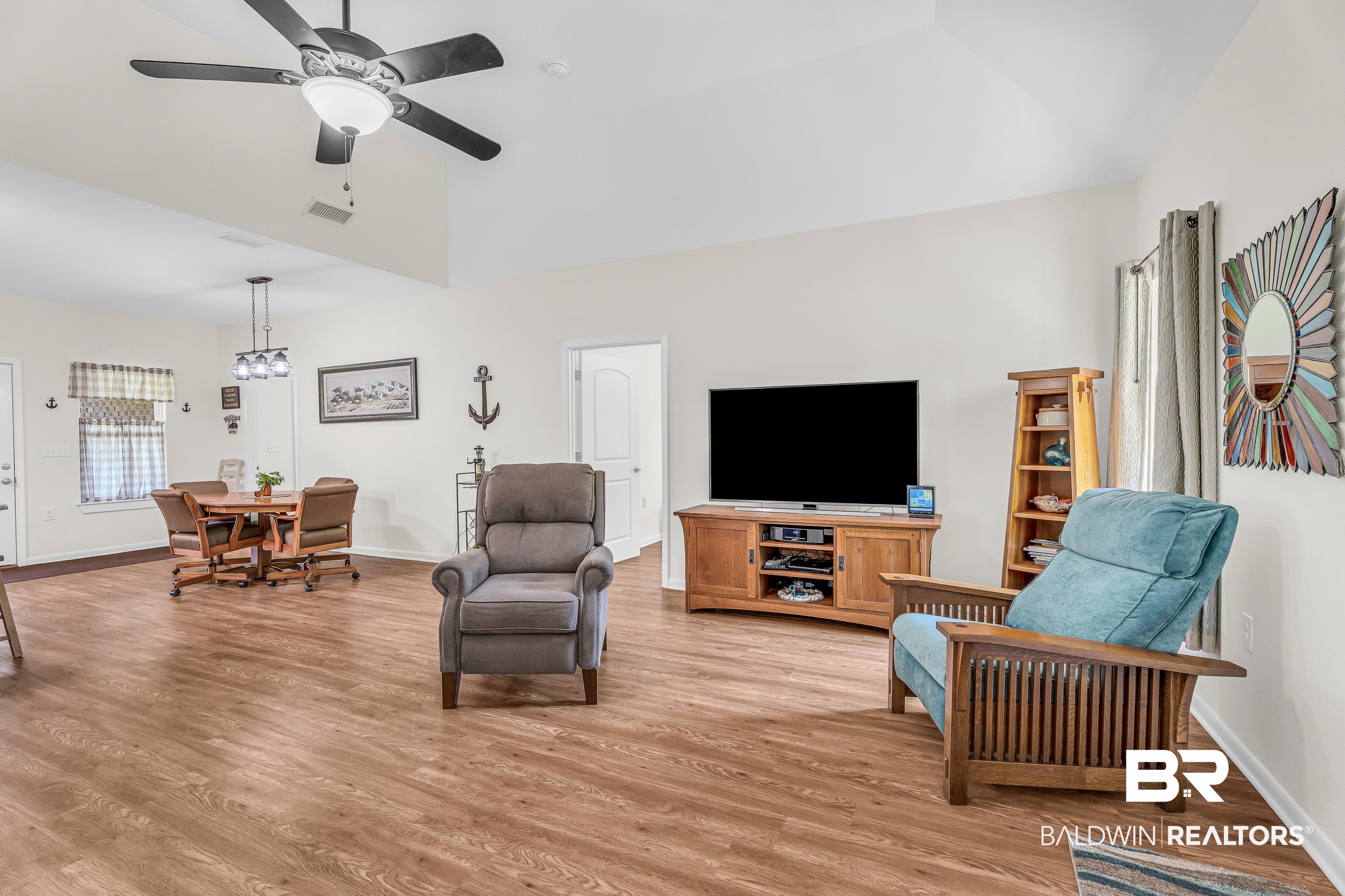 18255 Cactus Court Elberta, AL 36530 - Photo 11 of 53 Living area featuring lofted ceiling, a ceiling fan, and light wood-type flooring