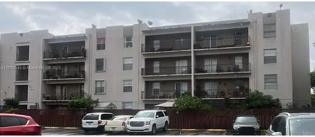 a couple of cars parked in front of a building