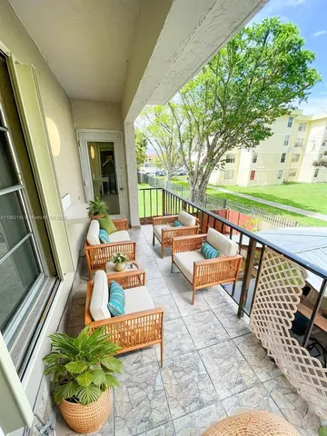 a outdoor space with patio the couches and a dining table with garden view
